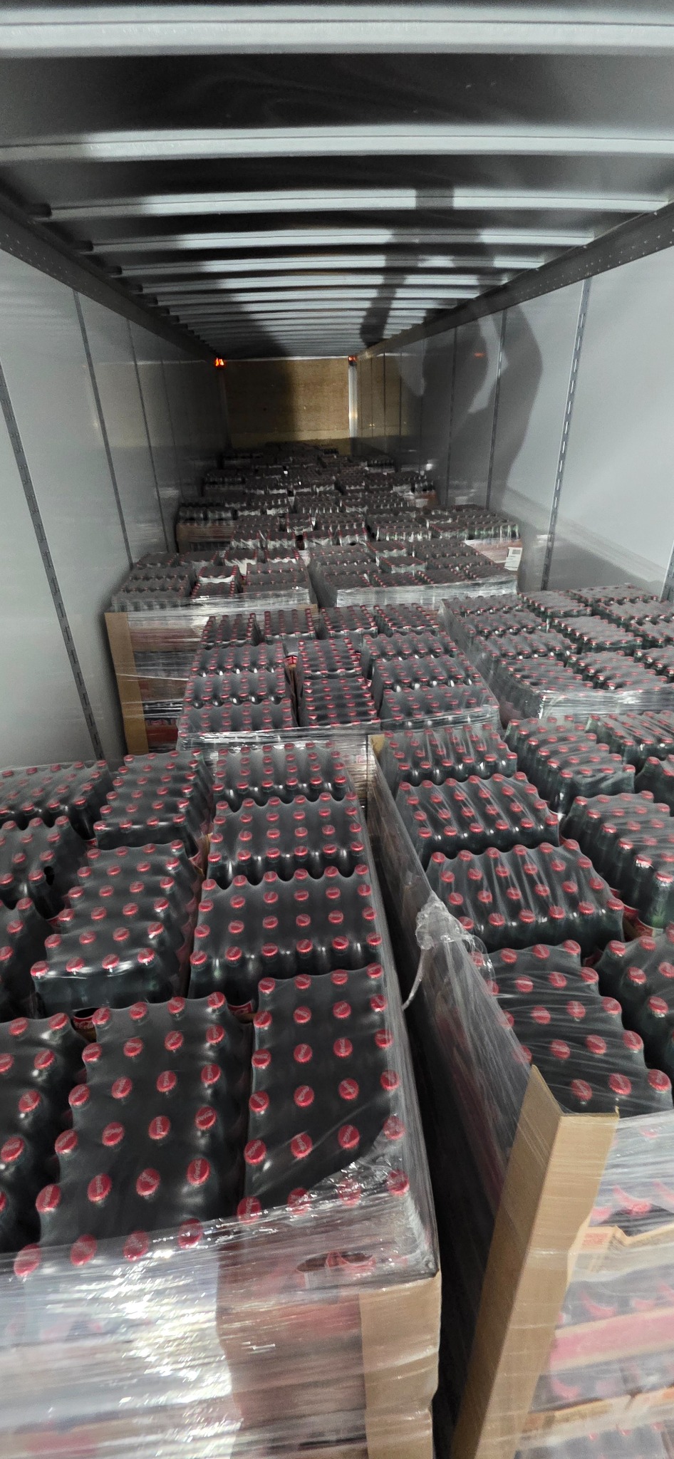 In-progress beverage trailer restack with pallets partially stabilized and lined up.